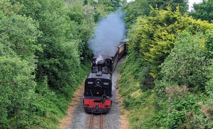 Steam train running through Bryn Gloch Caravan & Camping Park